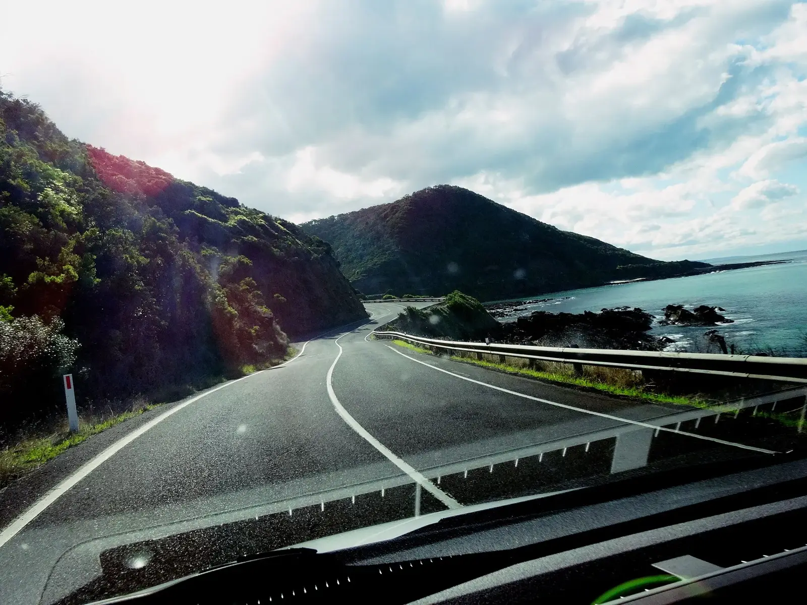 The Great Ocean Road curving along a cliff edge above the sea